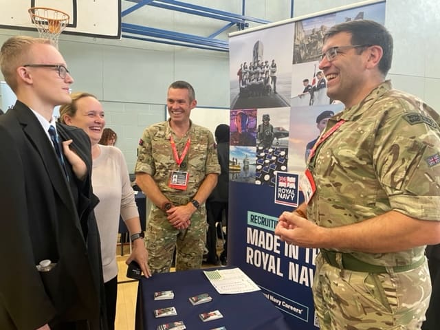 Jack Peake with his mum Sarah Peake talking to the team from the Royal Navy